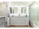 Modern bathroom features a double vanity, granite countertop, and glass shower at 9167 N 73Rd Ln, Peoria, AZ 85345