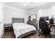 Cozy bedroom has a bed, and a gray wood dresser/desk at 9167 N 73Rd Ln, Peoria, AZ 85345