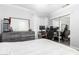 Comfortable bedroom features modern lighting, a dresser and desk at 9167 N 73Rd Ln, Peoria, AZ 85345