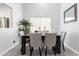 Dining room with a dark wood table, 6 chairs, and view into kitchen at 9167 N 73Rd Ln, Peoria, AZ 85345
