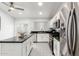 Modern kitchen features stainless steel appliances, white cabinetry, and granite countertops at 9167 N 73Rd Ln, Peoria, AZ 85345