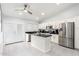 Bright kitchen with white cabinets, black countertops, stainless steel appliances, and tile flooring at 9167 N 73Rd Ln, Peoria, AZ 85345