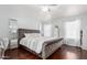 Relaxing main bedroom features a king bed, hardwood floors, and ample natural light at 9167 N 73Rd Ln, Peoria, AZ 85345
