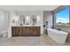 Modern bathroom features dual sinks, soaking tub under a window, and light wood cabinetry at 920 E Leslie E Ave, San Tan Valley, AZ 85140