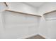 Bright walk-in closet features a simple rod and shelf design with white walls and neutral carpeting at 920 E Leslie E Ave, San Tan Valley, AZ 85140