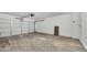 Spacious two car garage with white walls and concrete floors, providing ample parking and storage space at 920 E Leslie E Ave, San Tan Valley, AZ 85140