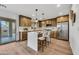 Modern kitchen featuring stainless steel appliances, an island with bar seating, and wood-look flooring at 920 E Leslie E Ave, San Tan Valley, AZ 85140