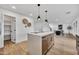 Kitchen island with white countertop and light wood cabinets at 920 E Leslie E Ave, San Tan Valley, AZ 85140
