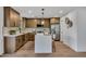 Modern kitchen showcasing stainless steel appliances, an island with bar seating, and wood-look flooring at 920 E Leslie E Ave, San Tan Valley, AZ 85140