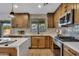 Modern kitchen with light wood cabinets, white countertops and stainless steel appliances at 920 E Leslie E Ave, San Tan Valley, AZ 85140