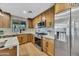 Modern kitchen featuring stainless steel appliances, light wood cabinets, and stylish countertops at 920 E Leslie E Ave, San Tan Valley, AZ 85140
