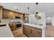 Modern kitchen featuring stainless steel appliances, an island with bar seating, and wood-look flooring at 920 E Leslie E Ave, San Tan Valley, AZ 85140