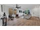 Spacious living room featuring a ceiling fan, wood floors, modern decor, and ample natural light at 920 E Leslie E Ave, San Tan Valley, AZ 85140