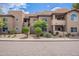 Exterior shot of a well-maintained condo building with lush landscaping and inviting entryway at 9451 E Becker Ln # 2004, Scottsdale, AZ 85260
