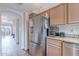 Spacious kitchen featuring stainless steel appliances, granite countertops, and an archway leading to the living room at 9451 E Becker Ln # 2004, Scottsdale, AZ 85260