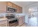 Modern kitchen with stainless steel appliances, granite countertops, and an open view to the living area at 9451 E Becker Ln # 2004, Scottsdale, AZ 85260