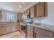 Bright kitchen featuring stainless steel appliances, granite countertops, stylish cabinets, and a large window at 9451 E Becker Ln # 2004, Scottsdale, AZ 85260