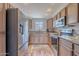 Well-lit kitchen showcasing stainless steel appliances, granite countertops, light wood cabinets, and modern finishes at 9451 E Becker Ln # 2004, Scottsdale, AZ 85260