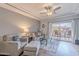 Comfortable living room with tray ceilings, ceiling fan, neutral furniture, and sliding door to private balcony at 9451 E Becker Ln # 2004, Scottsdale, AZ 85260