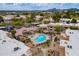 Aerial view of sparkling community pool and clubhouse amenities, surrounded by well maintained grounds at 9451 E Becker Ln # 2004, Scottsdale, AZ 85260