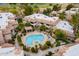 Aerial view of community pool and spa with lounge chairs, lush landscaping and ramada at 9451 E Becker Ln # 2004, Scottsdale, AZ 85260