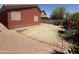 Spacious backyard with decorative rock and brick edging features a blank slate ready for customization at 10247 W Hilton Ave, Tolleson, AZ 85353
