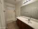 Bright bathroom features a shower and tub combination with a large vanity mirror and plenty of cabinet space at 10247 W Hilton Ave, Tolleson, AZ 85353
