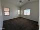 Spacious bedroom features a ceiling fan, carpeted floors and multiple windows, offering ample natural light at 10247 W Hilton Ave, Tolleson, AZ 85353