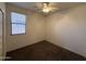 This bedroom features a window with blinds and carpeted floors, ready for your personal touch at 10247 W Hilton Ave, Tolleson, AZ 85353