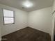 Neutral bedroom with a window providing natural light and carpet flooring at 10247 W Hilton Ave, Tolleson, AZ 85353