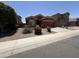 Single-story home with well-maintained landscaping, including desert plants and a mature shade tree at 10247 W Hilton Ave, Tolleson, AZ 85353