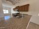Open kitchen with granite countertops, stainless steel appliances, and ample cabinet space at 10247 W Hilton Ave, Tolleson, AZ 85353