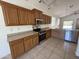 Spacious kitchen with stainless steel appliances, tile flooring, and plenty of cabinets at 10247 W Hilton Ave, Tolleson, AZ 85353