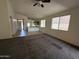 Open-concept living room with a ceiling fan, tile flooring, and abundant natural light at 10247 W Hilton Ave, Tolleson, AZ 85353