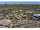 This aerial view highlights a modern desert home with a sparkling swimming pool at 10283 E Running Deer Trl, Scottsdale, AZ 85262
