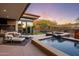 Tranquil backyard pool and spa area with a built-in grill, outdoor seating, and views of the desert landscape at 10283 E Running Deer Trl, Scottsdale, AZ 85262