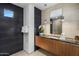 Modern bathroom with a black accent wall, a sleek vanity, and a walk-in shower at 10283 E Running Deer Trl, Scottsdale, AZ 85262