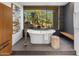 Bright bathroom featuring a freestanding tub with views of the desert landscape at 10283 E Running Deer Trl, Scottsdale, AZ 85262