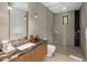 Modern bathroom featuring a glass-enclosed shower and a sleek vanity with a black marble countertop at 10283 E Running Deer Trl, Scottsdale, AZ 85262