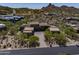 A stylish modern home has a desert landscape with mountain views at 10283 E Running Deer Trl, Scottsdale, AZ 85262