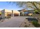 Contemporary home with a circular driveway, desert landscaping, and modern architectural features at 10283 E Running Deer Trl, Scottsdale, AZ 85262