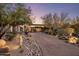 Beautiful home with desert landscaping, mature trees, and a long driveway leading to the entrance at 10283 E Running Deer Trl, Scottsdale, AZ 85262