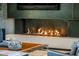 Cozy indoor fireplace providing warmth and ambiance, complete with modern design and a stylish mantel at 10283 E Running Deer Trl, Scottsdale, AZ 85262