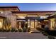 Stunning modern home featuring a water feature, desert landscaping, and architectural stone accents at 10283 E Running Deer Trl, Scottsdale, AZ 85262