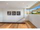 Bright hallway with hardwood floors, modern art, and a large window with mountain views at 10283 E Running Deer Trl, Scottsdale, AZ 85262