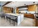 Modern kitchen featuring a large island, stone accents, and stainless steel appliances at 10283 E Running Deer Trl, Scottsdale, AZ 85262