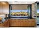 Well-lit kitchen featuring light wood cabinetry, granite countertops, and a scenic outdoor view at 10283 E Running Deer Trl, Scottsdale, AZ 85262