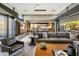 Open living space with comfortable seating, stone walls, and seamless connection to outdoor area at 10283 E Running Deer Trl, Scottsdale, AZ 85262
