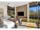 Main bedroom featuring a large window with desert views and a flat screen television at 10283 E Running Deer Trl, Scottsdale, AZ 85262