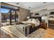 Bright main bedroom with a stone accent wall, outdoor access, and modern décor at 10283 E Running Deer Trl, Scottsdale, AZ 85262